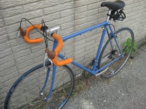 Blue bike with orange handlebars