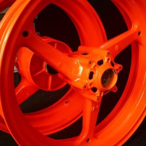 Close up of orange powder coated wheel