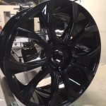 large black powder coated wheel coming off line